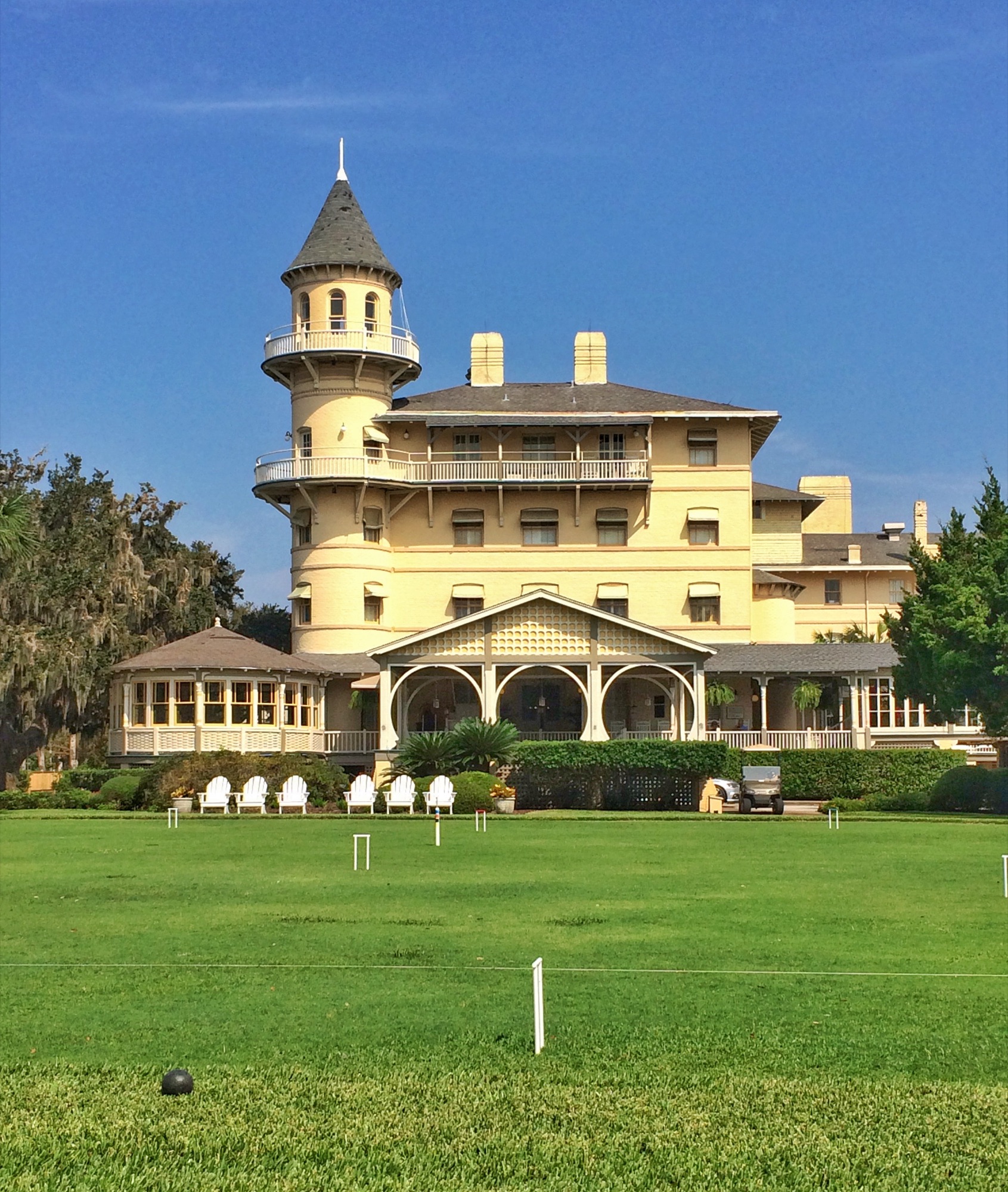 The grand Victorian clubhouse of the Jekyll Island Club, turret above the croquet lawn