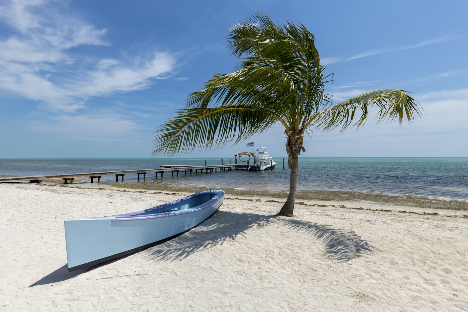 A canoe by the palms on the water in Key Largo
