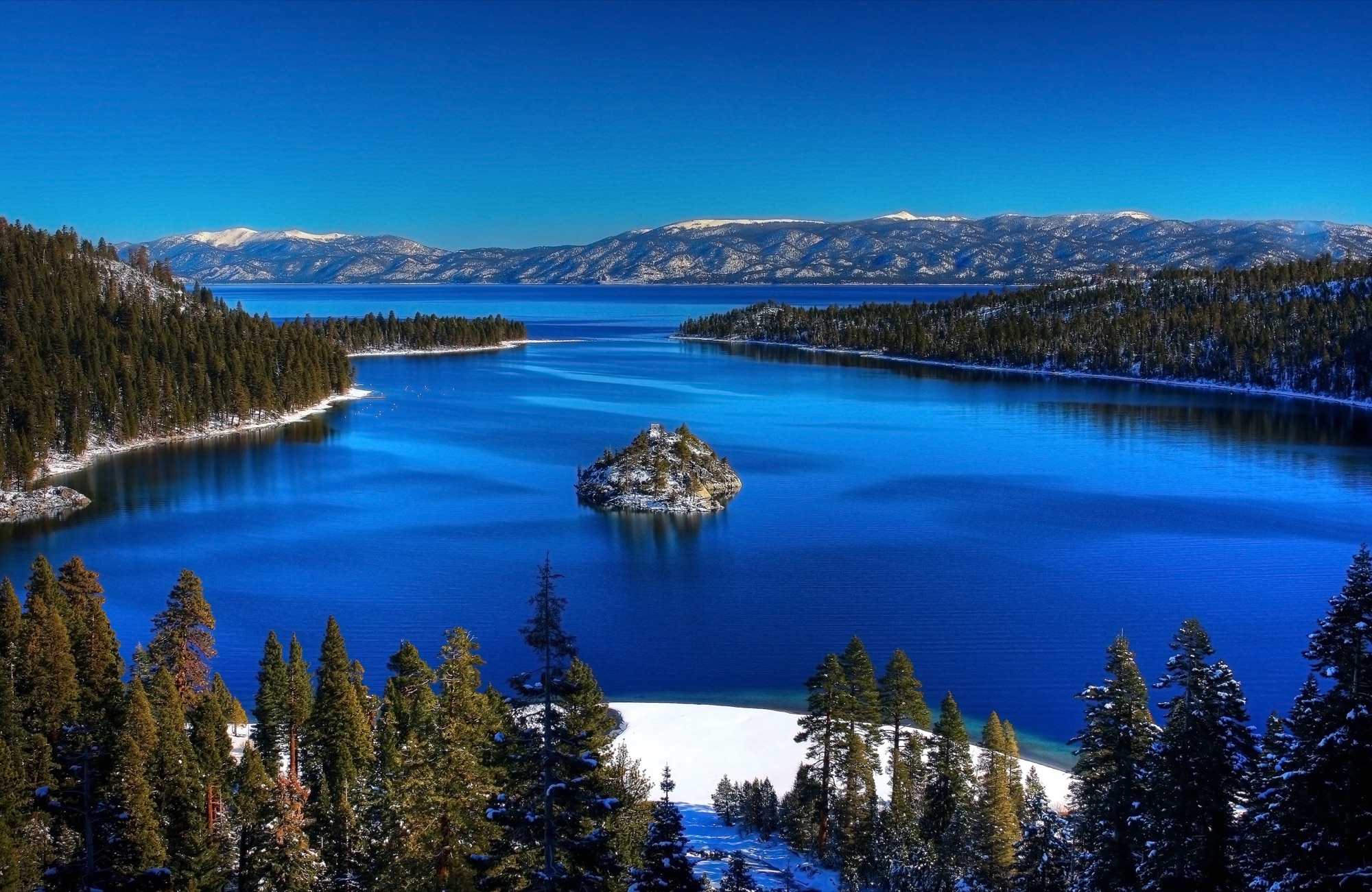 The turquoise expanse of Emerald Bay with Fannette Island rising from the water, framed by forested Sierra Nevada slopes.
