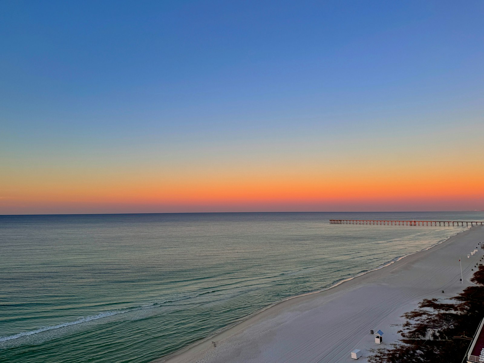 A Panama City Beach sunset with the pier in the distance