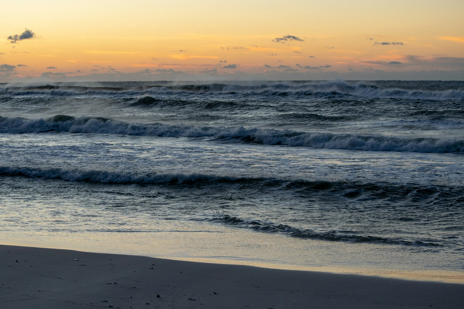 Sunset surf on the white sand of Pensacola Beach
