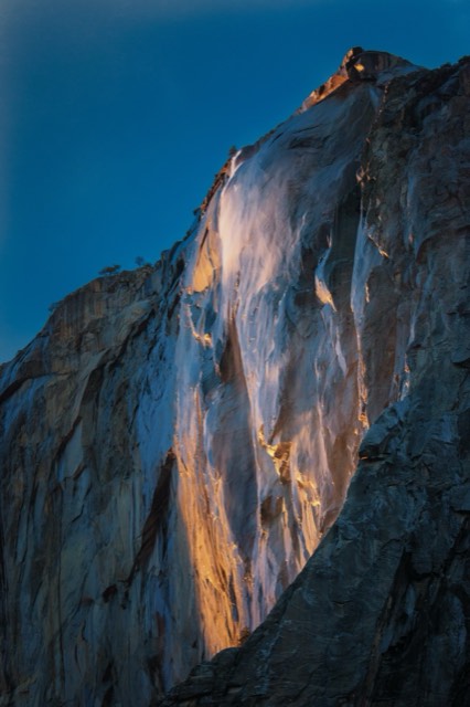 Horsetail Fall glowing orange like fire against El Capitan at sunset — the Yosemite Firefall