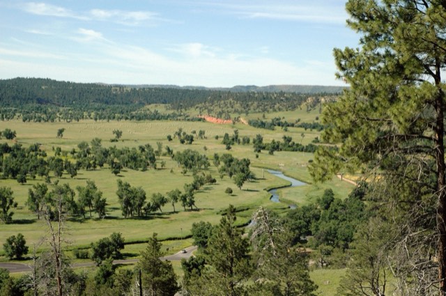 The Belle Fourche River winding through the green valley below Devils Tower