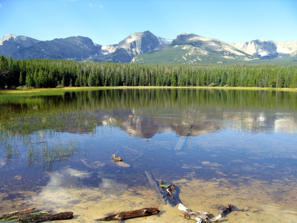 The still, reflective water of Bierstadt Lake below the peaks of Rocky Mountain National Park