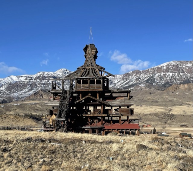 The Smith Mansion and the snow-capped Absarokas along the Buffalo Bill Cody Scenic Byway