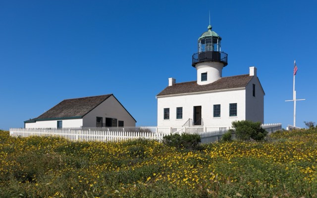 The Old Point Loma Lighthouse and keeper's quarters amid wildflowers at Cabrillo National Monument