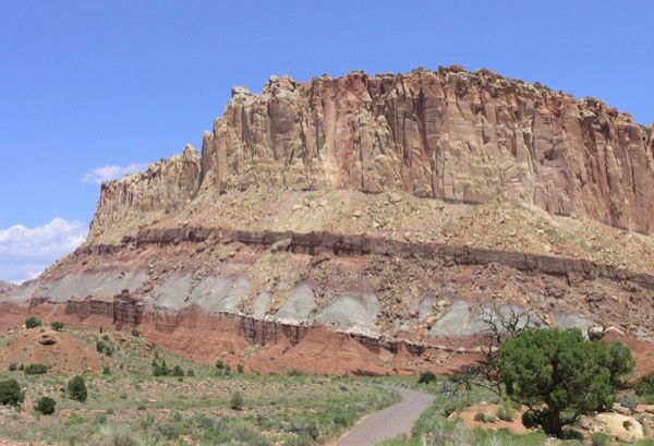 Layered red cliffs above the paved Capitol Reef Scenic Drive