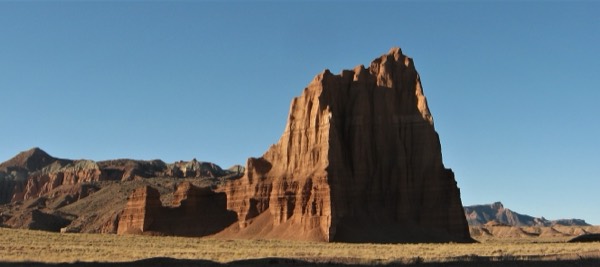 The Temple of the Sun monolith rising from the golden grass of Cathedral Valley