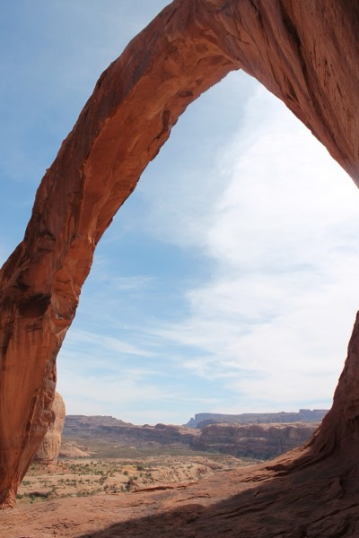 Looking out from beneath the massive span of Corona Arch near Moab