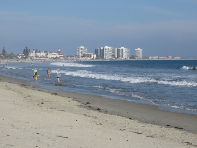 The wide sandy sweep of Coronado Beach with the red-roofed Hotel del Coronado down the shore
