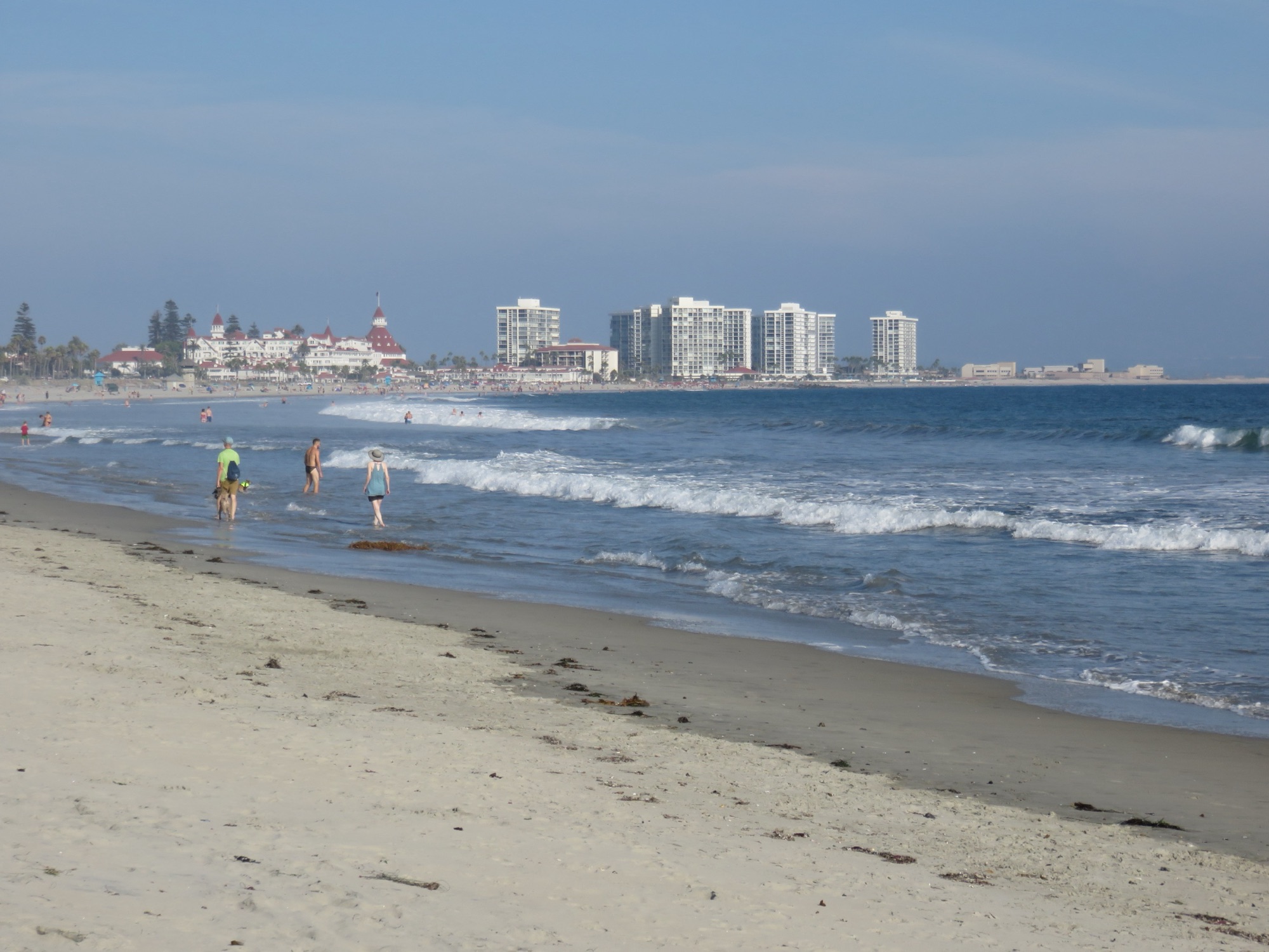 The wide sandy sweep of Coronado Beach with the red-roofed Hotel del Coronado down the shore