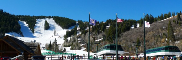 Snowy ski runs and lifts at Deer Valley Resort under a blue sky