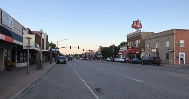 Sheridan Avenue at dusk with the glowing Irma Hotel neon, Cody, Wyoming