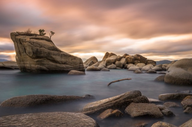 Bonsai Rock and scattered boulders along the glassy clear water of Lake Tahoe's East Shore.
