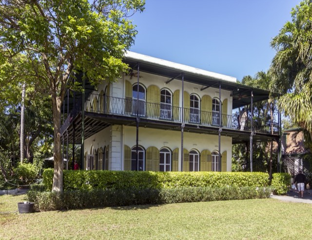 The yellow-shuttered Ernest Hemingway Home and its wraparound veranda in Key West