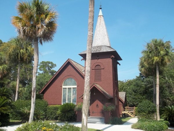 The 1904 gothic-revival Faith Chapel with its shingled steeple, framed by palms