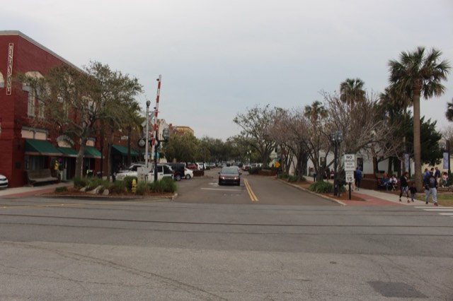 Historic Centre Street in Fernandina Beach on Amelia Island — red-brick Victorian storefronts, palms, and railroad tracks