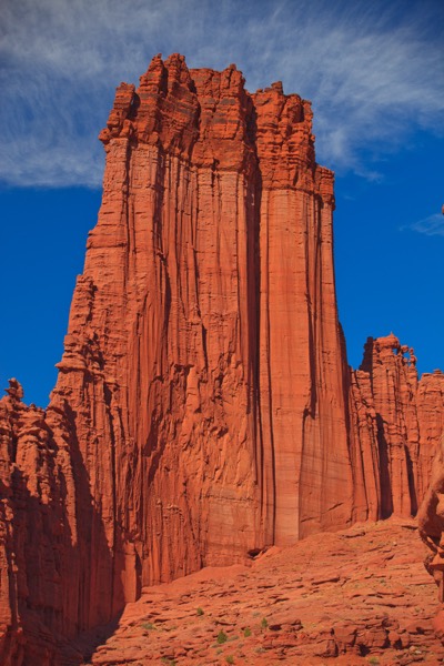 The deep-red spires of the Fisher Towers against a vivid blue sky