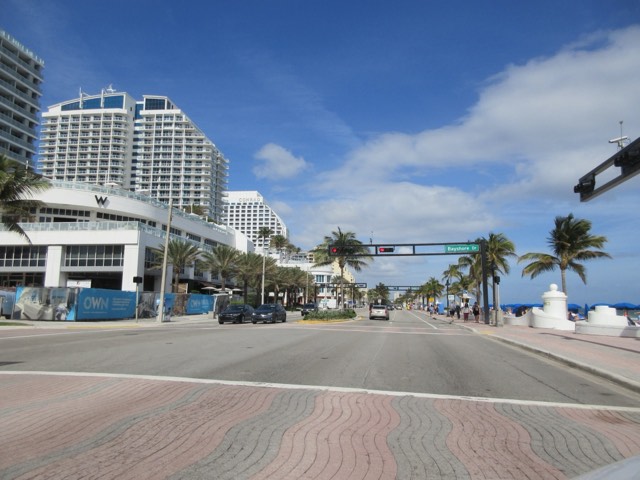 The A1A beachfront in Fort Lauderdale, with palms along the boulevard and the signature white wave-wall promenade beside the Atlantic