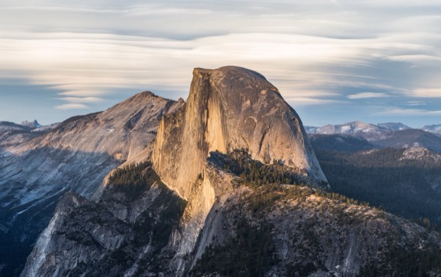 Half Dome's sheer granite face in golden light, seen from Glacier Point