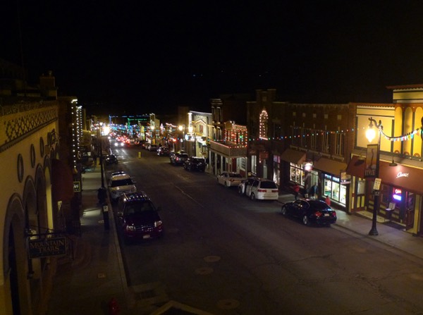 Park City's historic Main Street at night with holiday string lights and the Egyptian Theatre marquee