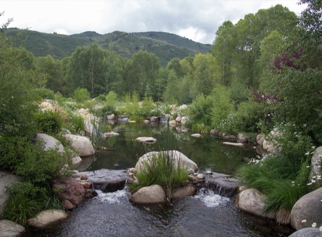 The pond and wildflower garden of the John Denver Sanctuary with the mountains beyond