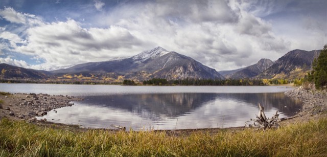 Peak One of the Tenmile Range reflected in Lake Dillon with autumn color along the shore