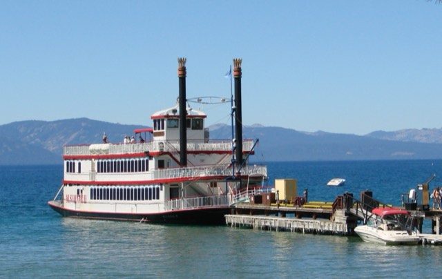 The MS Dixie II paddlewheeler cruising the blue water of Lake Tahoe on a clear day.