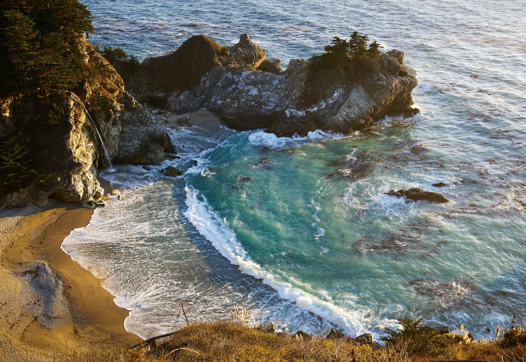McWay Falls dropping onto the sheltered cove beach at Julia Pfeiffer Burns State Park