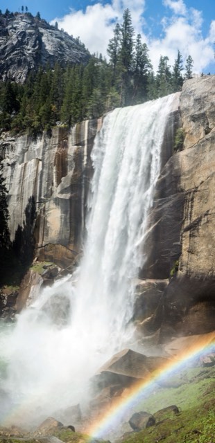 Vernal Fall thundering over its cliff with a rainbow in the mist, on the Mist Trail