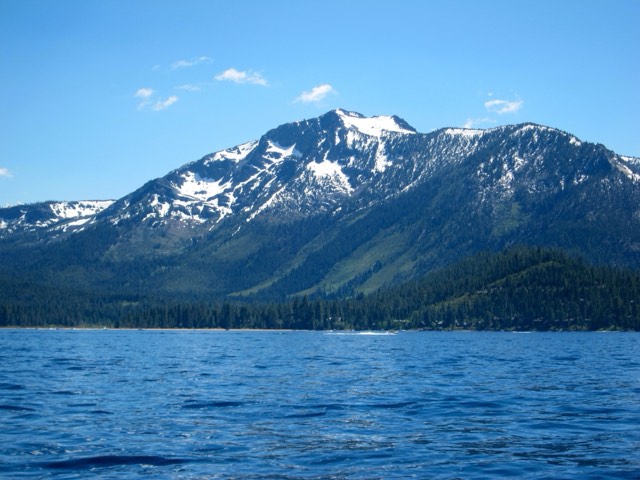 Snow-streaked Mount Tallac rising above Lake Tahoe and the surrounding pine forest.