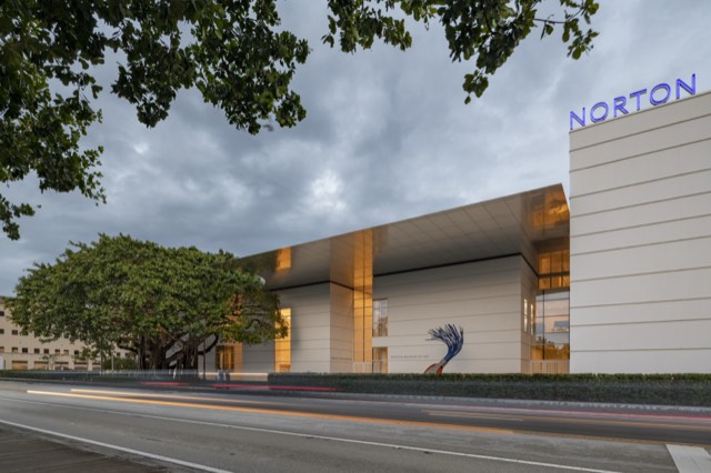 The Norton Museum of Art's cantilevered entrance and banyan tree at dusk