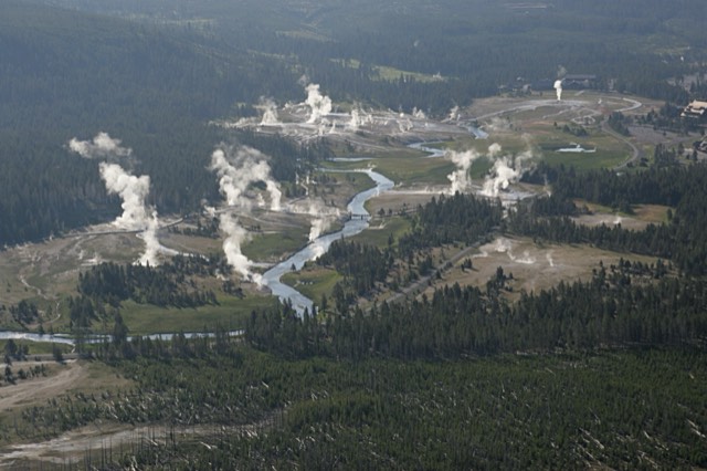 An aerial view of the Upper Geyser Basin with steaming geysers