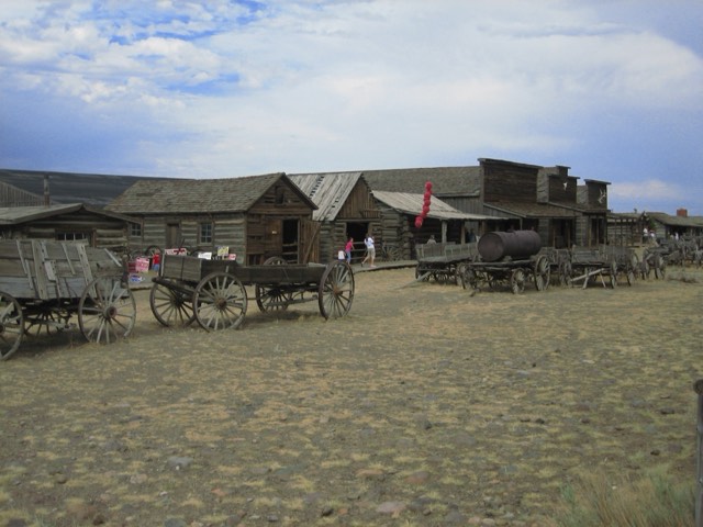 Frontier cabins and antique wagons at Old Trail Town near Cody