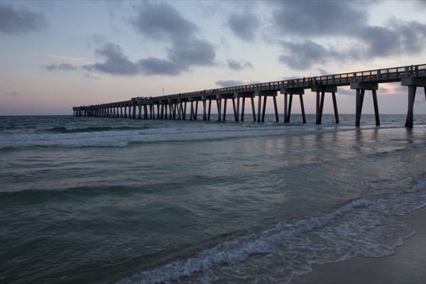 The Panama City Beach pier reaching into the Gulf at dusk