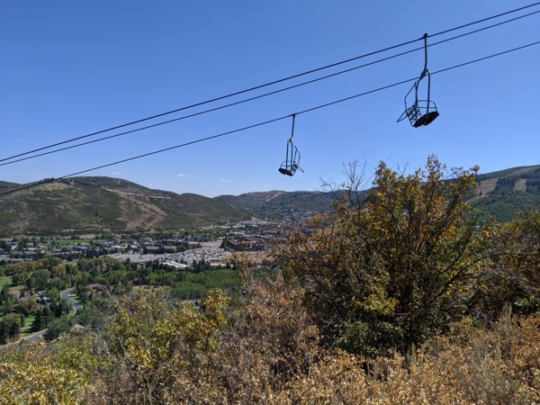 A chairlift at Park City Mountain Resort overlooking the town and valley in summer