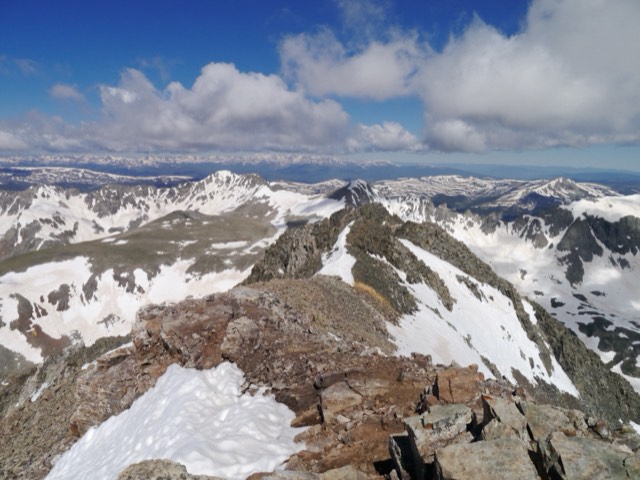 The summit ridge of Quandary Peak, a Colorado 14er, above a sea of snowy peaks