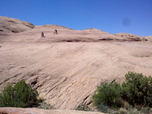 The petrified-dune terrain of the Slickrock Bike Trail under a blue sky
