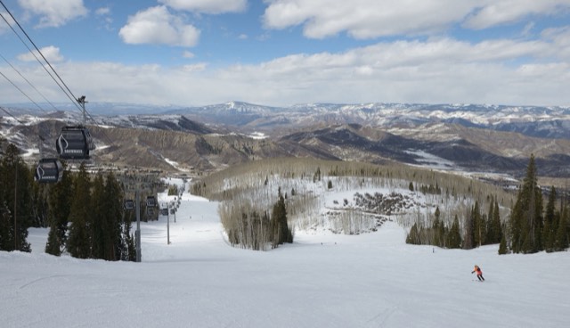 The Snowmass gondola and a groomed run descending toward Snowmass Village