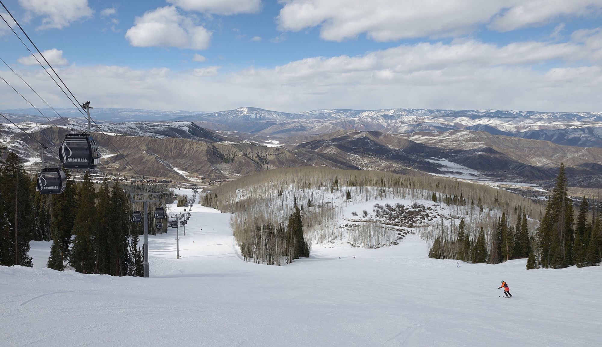 The Snowmass gondola and a groomed run descending toward Snowmass Village