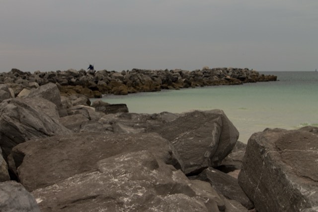 The rock jetty and turquoise Gulf water at St. Andrews State Park near Panama City Beach