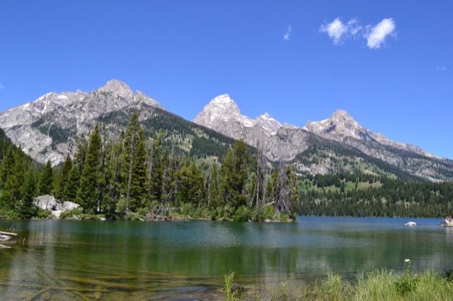 Taggart Lake reflecting the Grand Teton and the Cathedral Group