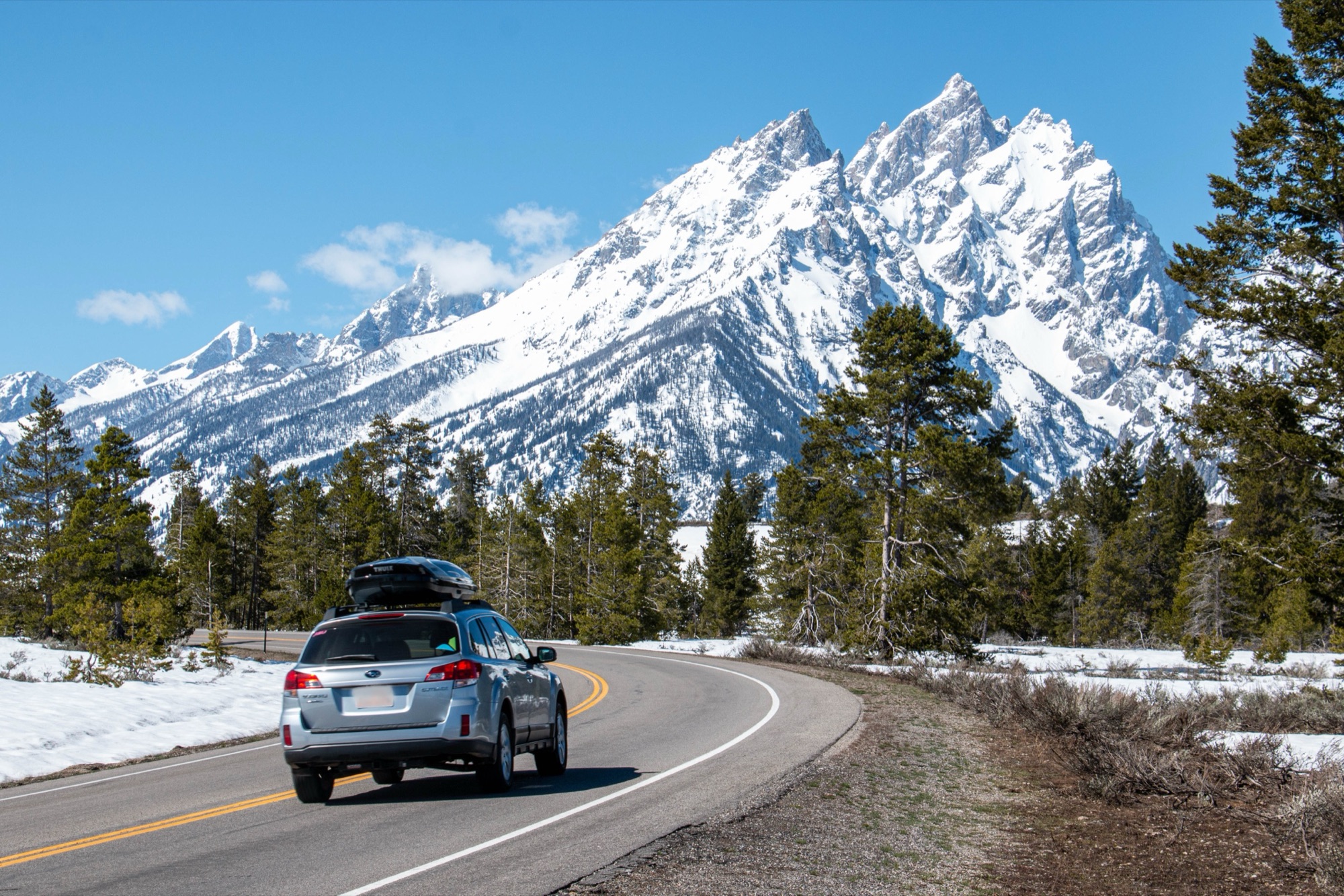 Teton Park Road running toward the snow-capped Grand Teton