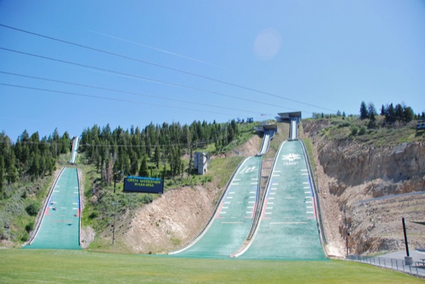 The Olympic ski-jump ramps at Utah Olympic Park under a blue sky