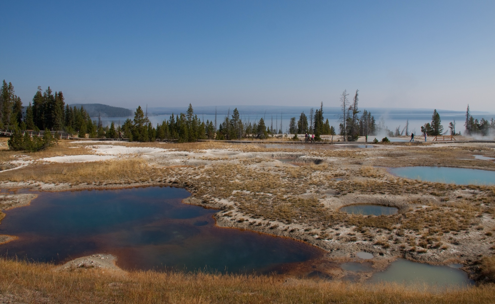 Colorful hot pools of the West Thumb Geyser Basin beside Yellowstone Lake