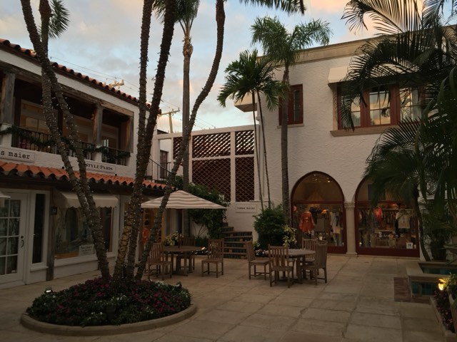 A Mediterranean 'via' courtyard with boutiques and cafe tables on Worth Avenue, Palm Beach
