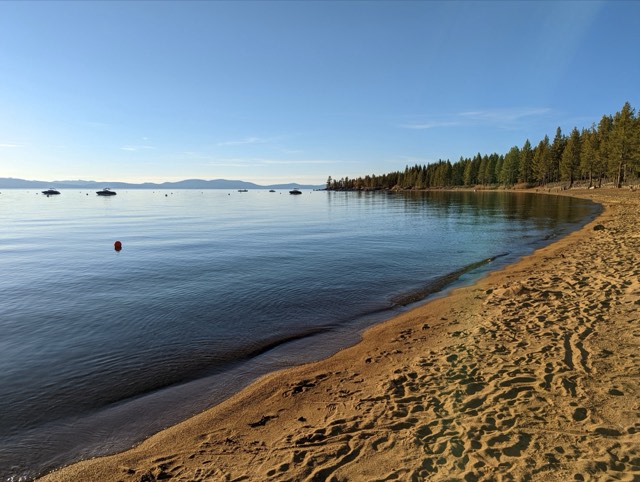 The sandy beach and blue water of Zephyr Cove on Lake Tahoe's Nevada shore.