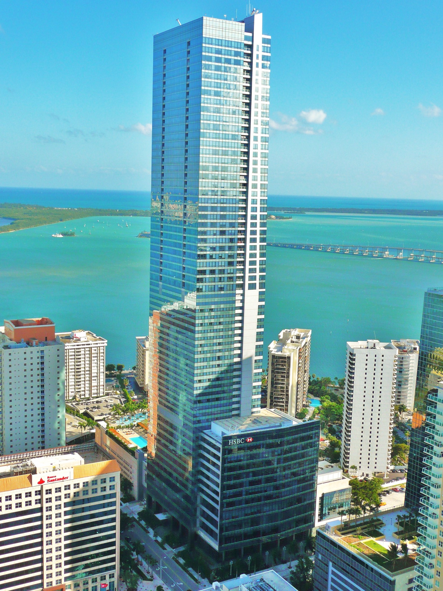 The Four Seasons Hotel Miami's blue-glass tower rising over turquoise Biscayne Bay in Brickell
