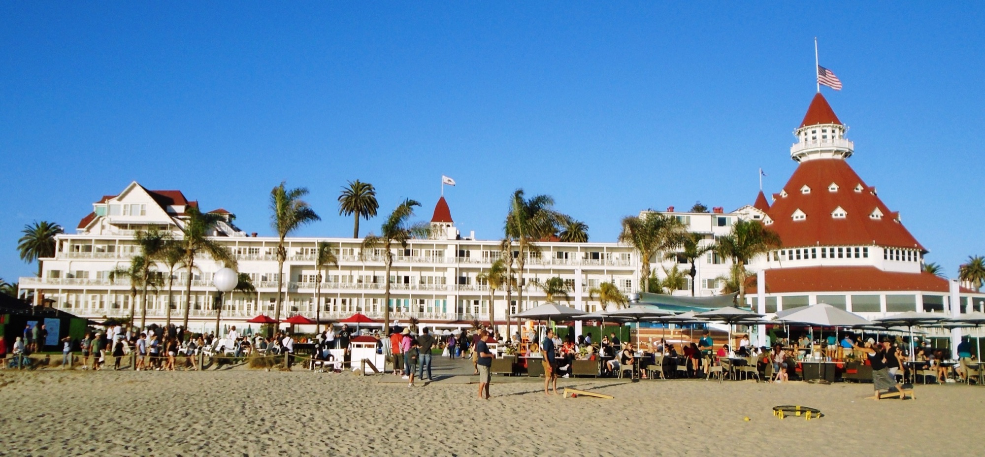 The red-roofed Victorian towers of the Hotel del Coronado seen from Coronado Beach