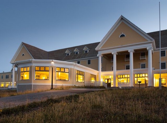 The colonial-revival Lake Yellowstone Hotel lit at dusk
